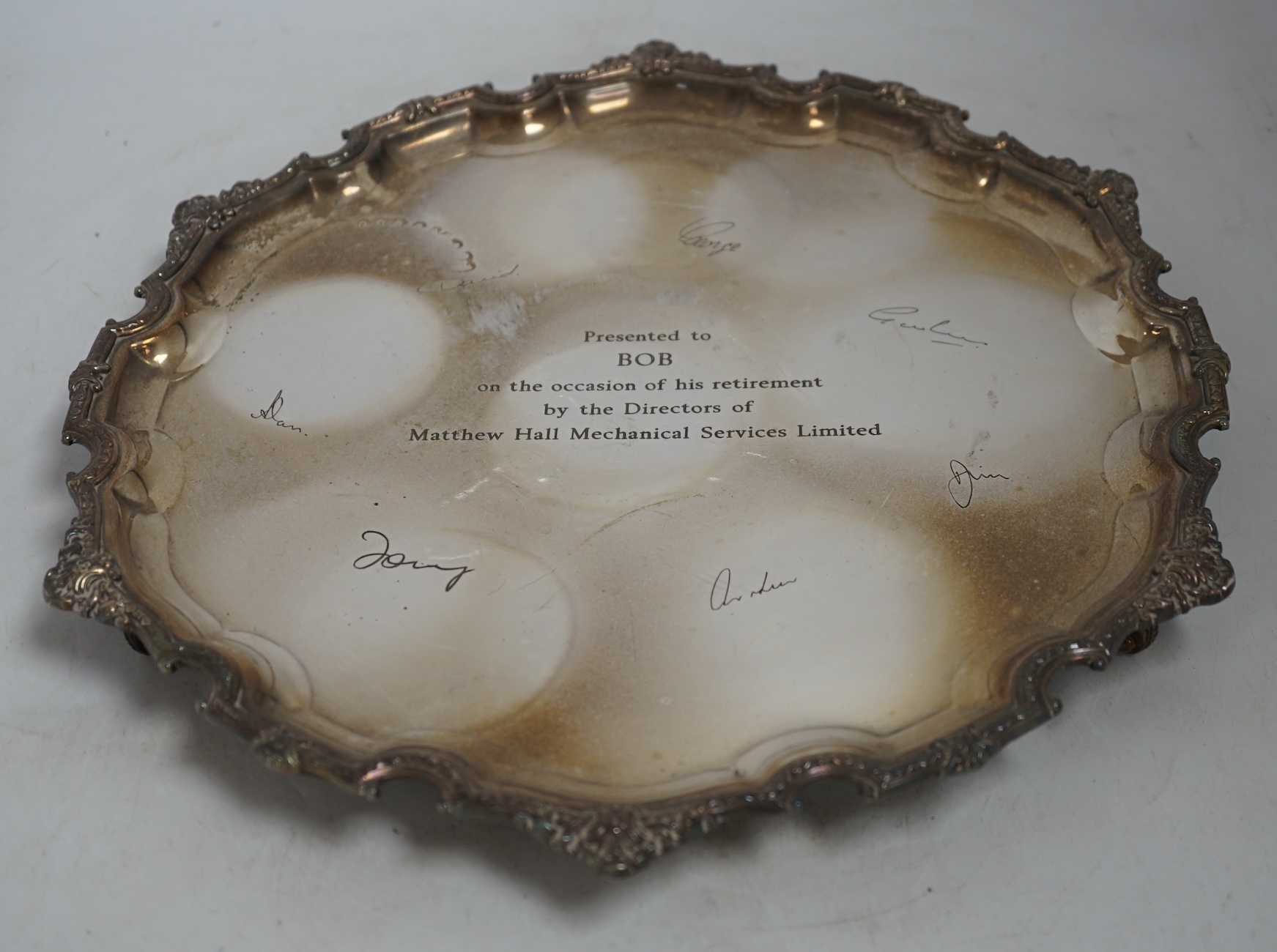 A quantity of silver plate to include a twin handled trophy, salvers and an embossed plaque depicting deer. Condition - varies, poor to fair